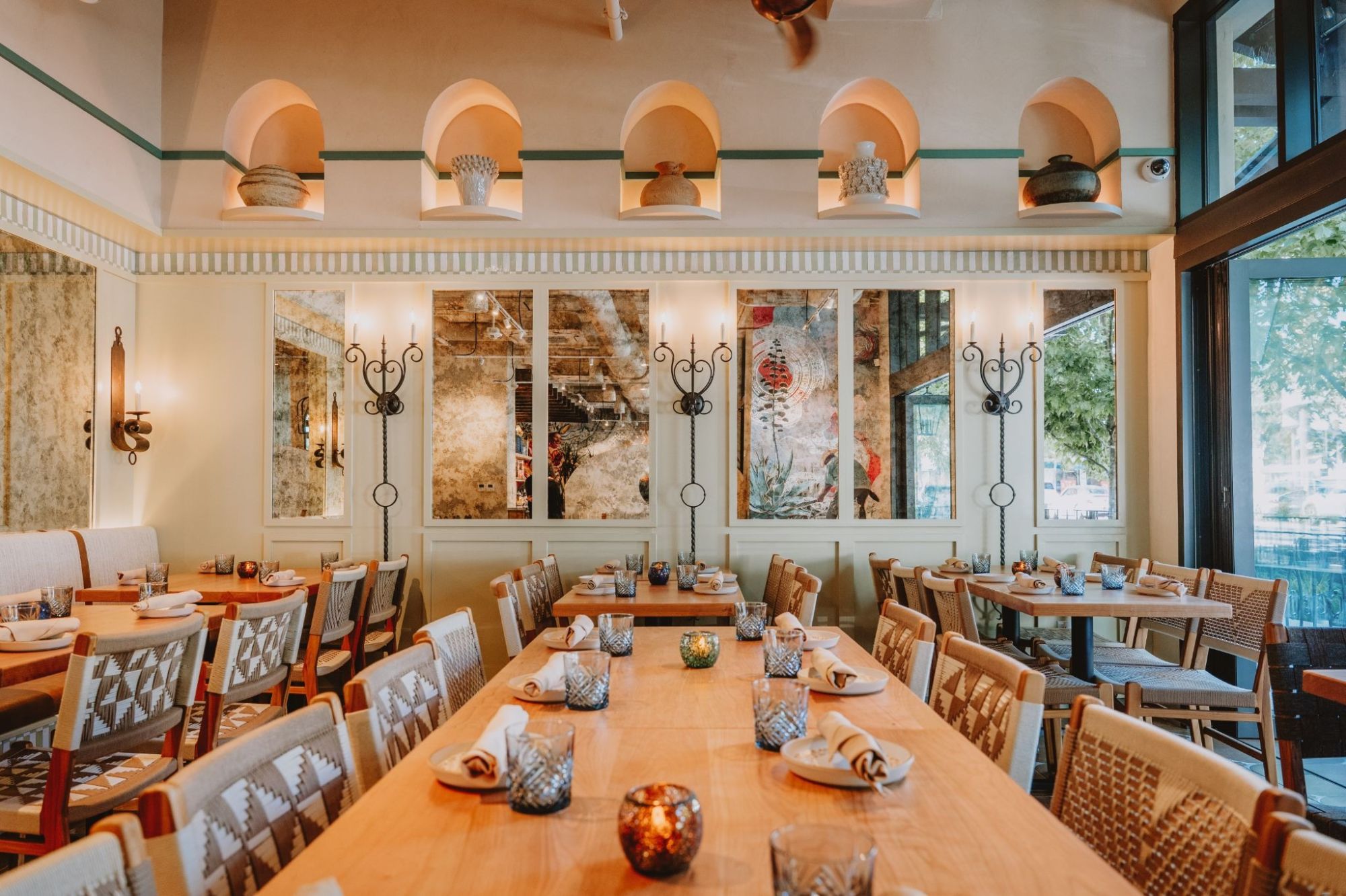 Dining room with arched pottery niches and candlelit tables